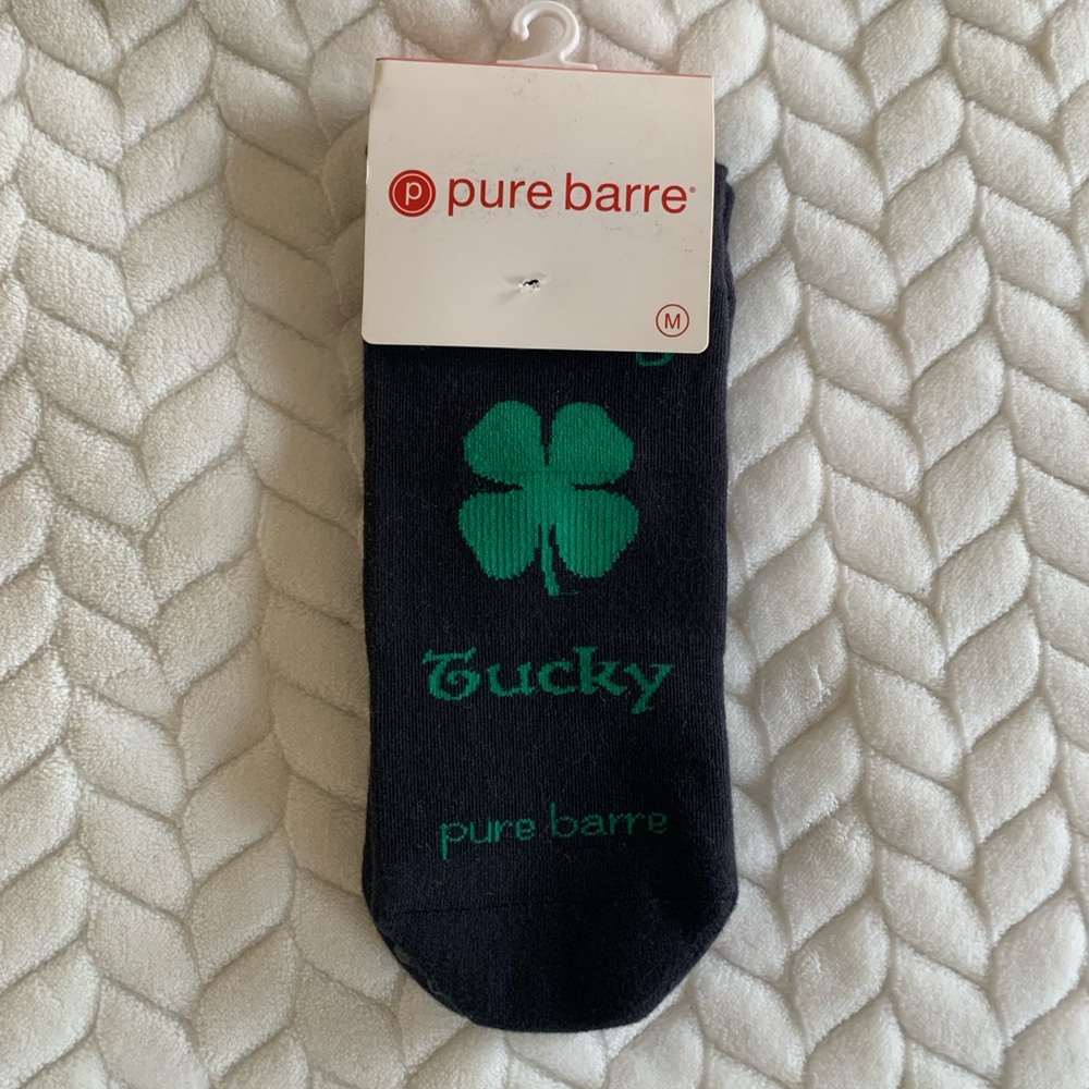 Pure Barre “Feeling Tucky” Black and Green Grip Socks with Green Clover Design
